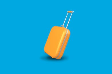 Orange luggage on a blue backdrop