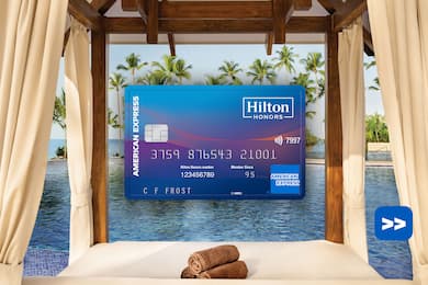 Hilton Honors American Express Surpass Card in front of a swimming pool background